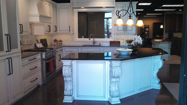 white acanthus leaf corbel on white kitchen island with black marble counter boston cabinet cures